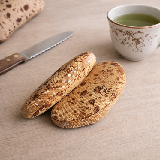 Sourdough bread play food with knife and cup of green tea on wooden surface