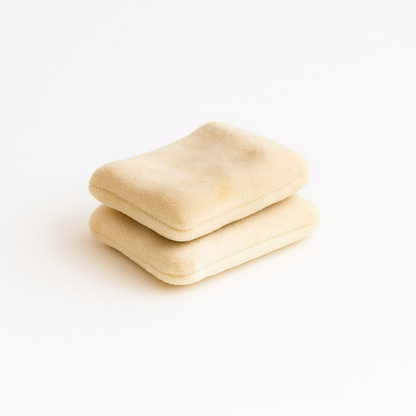 Two handmade velvet Gouda cheese toy pieces stacked on a white background – part of Normadot’s Norma’s Deli Collection.