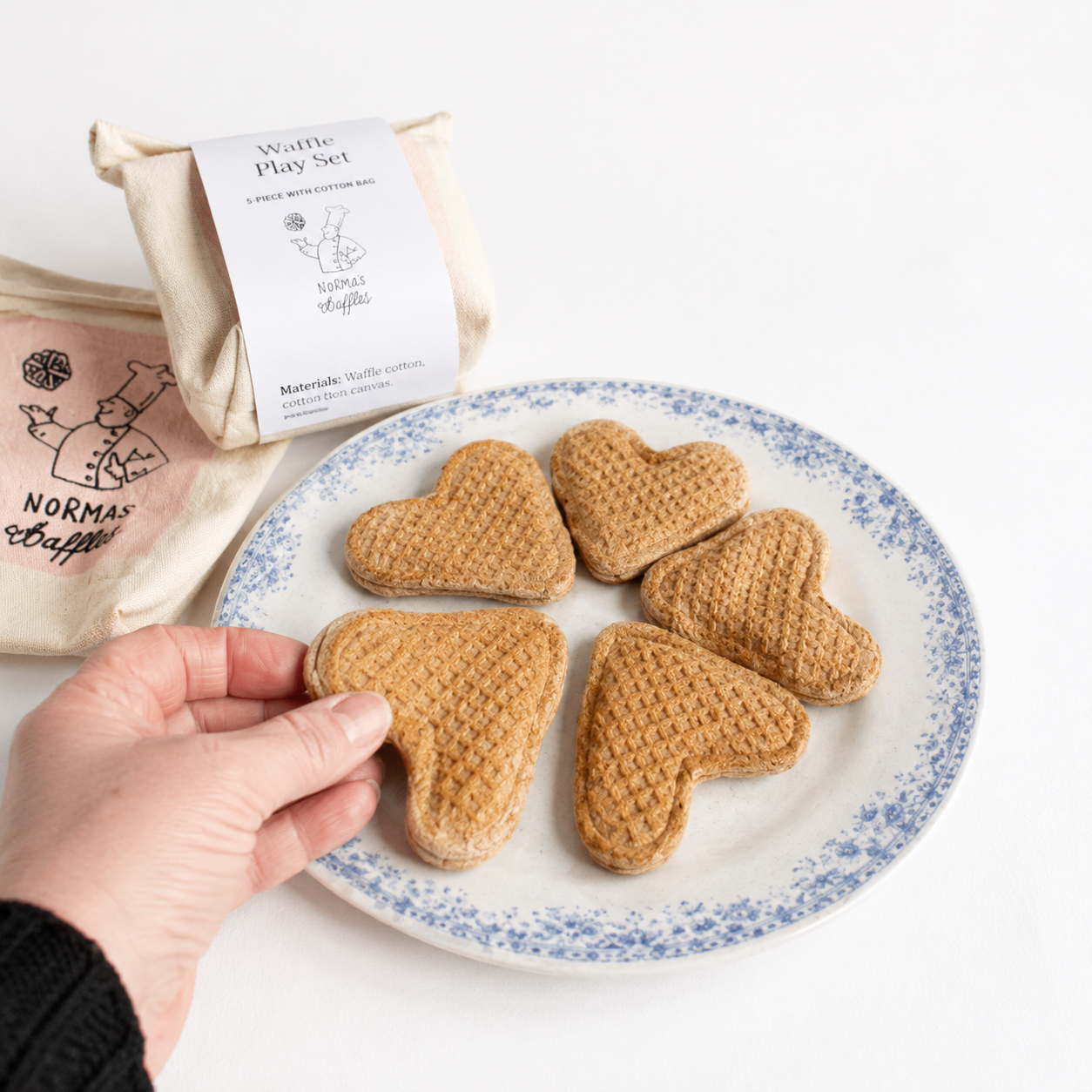 Heart-shaped fabric waffle play food on a plate with packaging in the background
