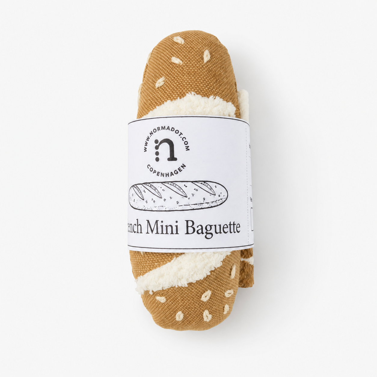 
Handmade fabric mini baguette wrapped with a white product label on a clean white studio background.
