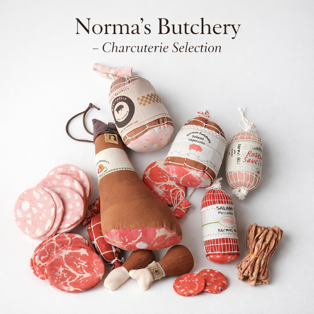 Assorted fabric charcuterie products with 'Norma's Butchery' branding on a light background