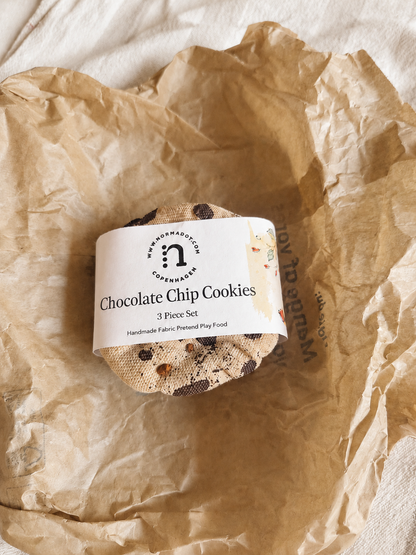 Three handmade fabric chocolate chip cookies wrapped with a normadot product label.