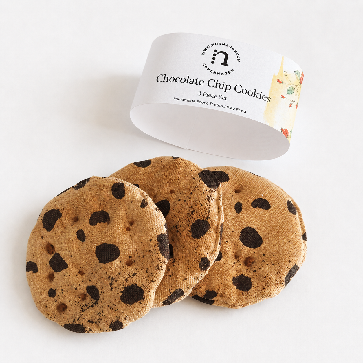 Three handmade cotton fabric chocolate chip cookies with a normadot paper band for pretend play.