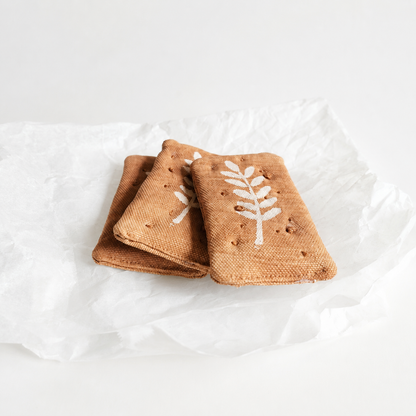 Handmade fabric whole wheat crackers for pretend play kitchens, made with plant-based print and soft textile details in Denmark.